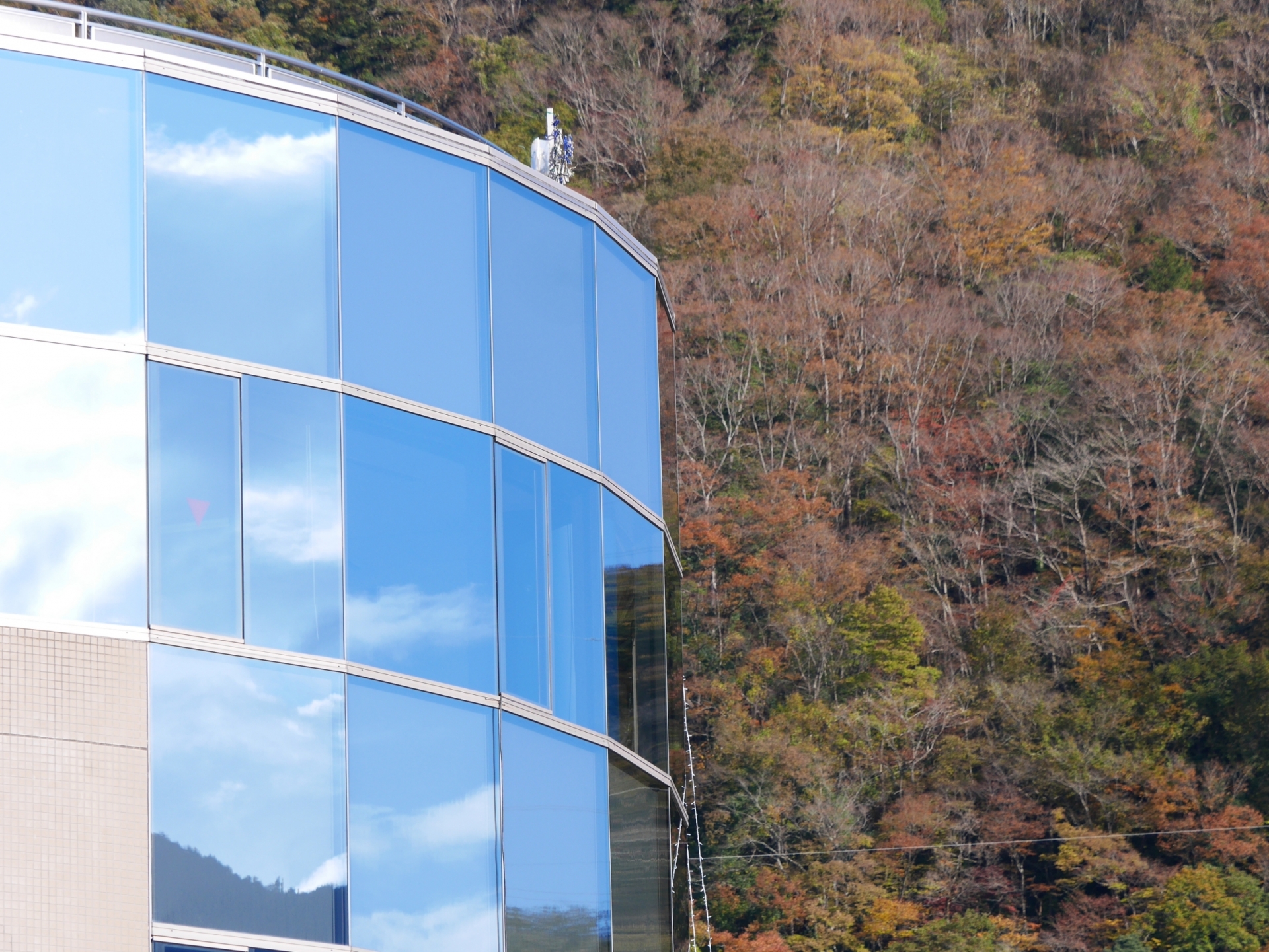 Window glass polished to a mirror finish that clearly reflects the sky