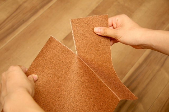 Abrasive material being cut into necessary sizes before use for cleaning